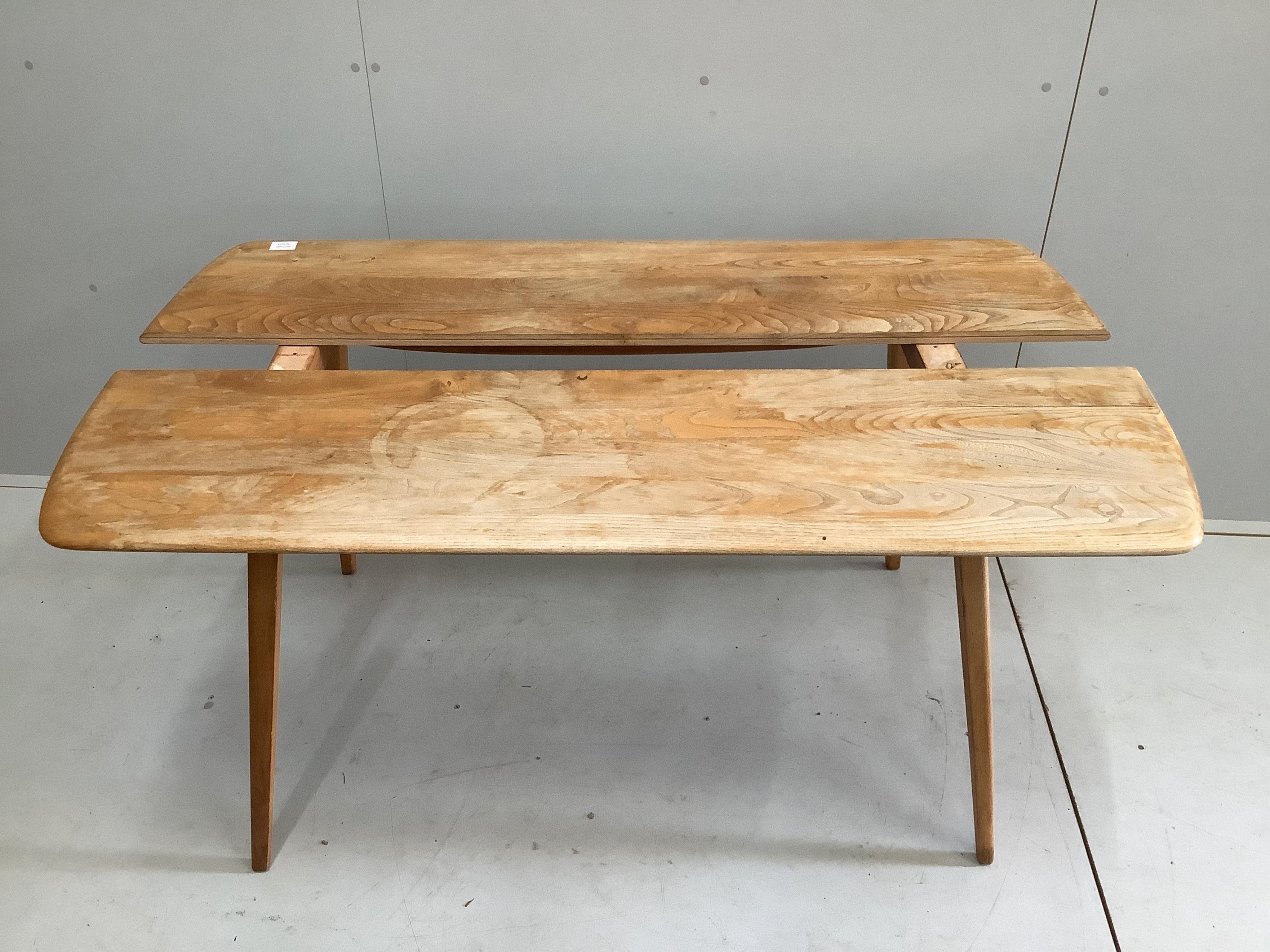 A mid century Ercol elm and beech rectangular dining table, width 135cm, depth 71cm, height 72cm. Condition - poor